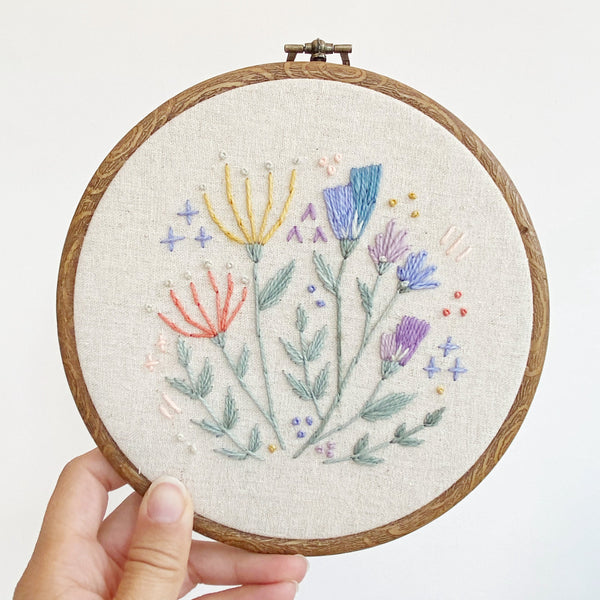 Folk style floral embroidery in faux wood embroidery hoop